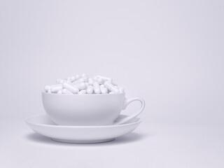 Cup full of  pills.    
