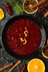 Cranberry sauce and ingredients on black smokey background