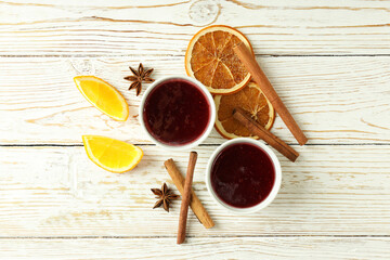 Cranberry sauce and ingredients on white wooden background
