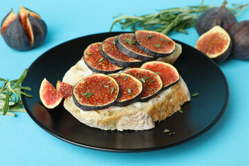 Plate with bruschetta with fig on blue background