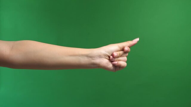 Close Up Of Woman'S Hand Snapping Her Finger Doing The Hand Gesture Isolated On Green Screen Background
