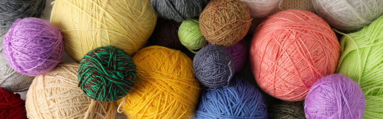 Balls of yarn all over background, top view