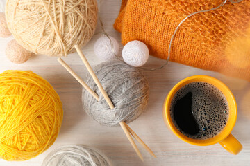 Concept of knitting on white wooden table, top view