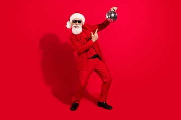 Fototapeta na wymiar Full length photo of positive happy clubber old man point finger disco ball holiday isolated on red color background