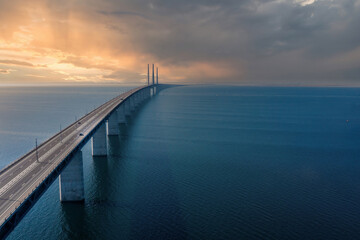Obraz premium Panoramic aerial view of the Oresundsbron bridge between Denmark and Sweden, at sunset. Oresund Bridge close up view from above