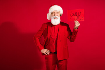 Photo of charming old happy man hold hands waist santa claus card holiday new year xmas isolated on...