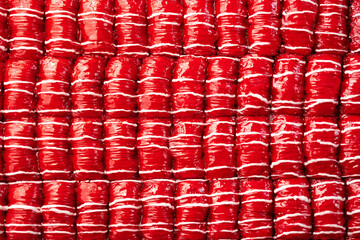 Red colored Turkish dessert baklava placed in rows