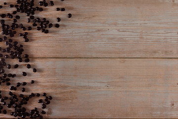 Coffee beans on wood. Copy space. Selective focus.