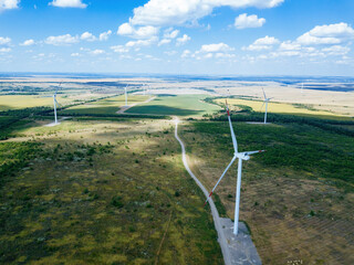 Wind turbines at the countryside in summer day, aerial view