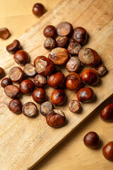 Fresh sweet edible chestnuts on wooden table