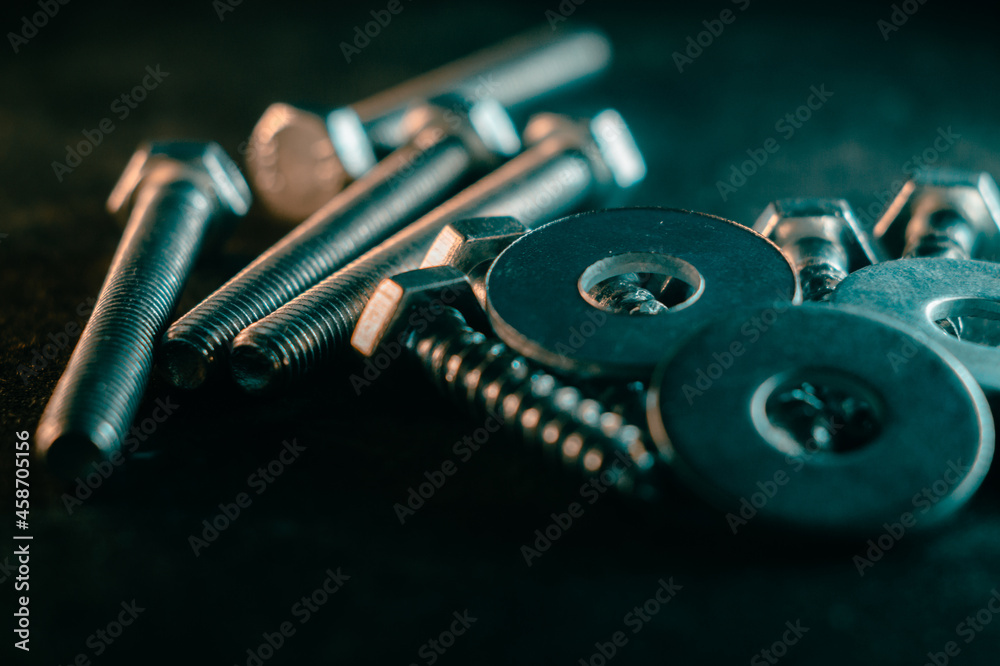 Wall mural Pile of screws on a dark background