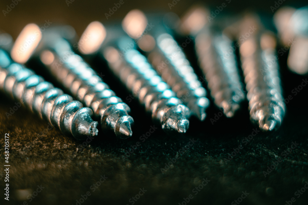 Sticker Pile of screws on a black background