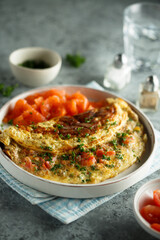 Traditional homemade omelette with tomatoes and salmon