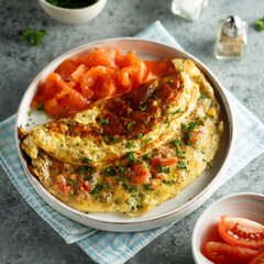 Traditional homemade omelette with tomatoes and salmon