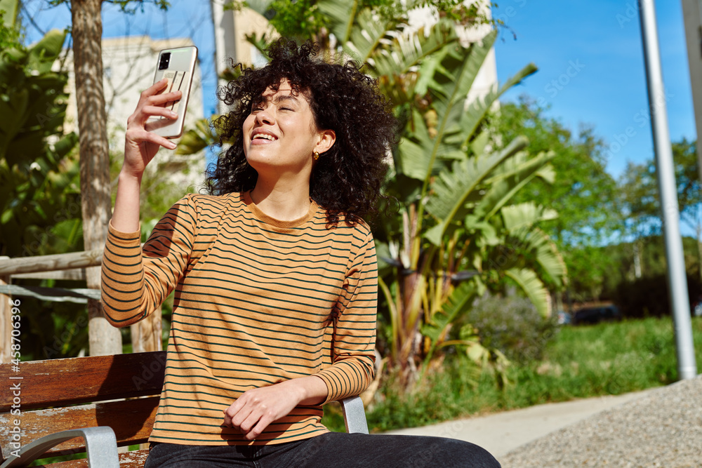 Poster happy young woman taking a video call