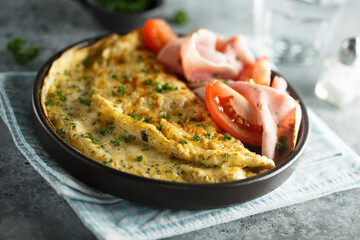 Traditional omelette with tomatoes and ham