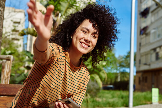 Smiling Girl Blocking The Camera With Her Hand