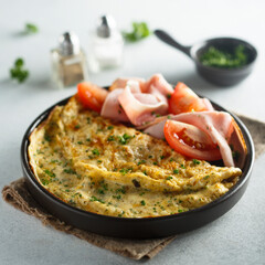 Traditional omelette with tomatoes and ham
