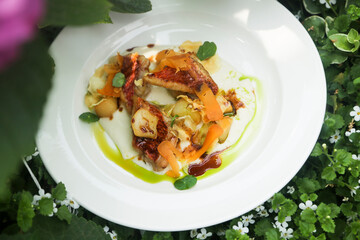 Roasted fish with vegetables and green oil