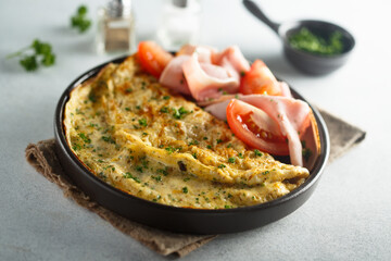 Traditional omelette with tomatoes and ham