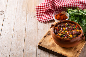 Traditional mexican tex mex chili con carne on wooden table.Copy space