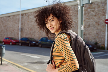 Attractive young woman looking at you outdoors