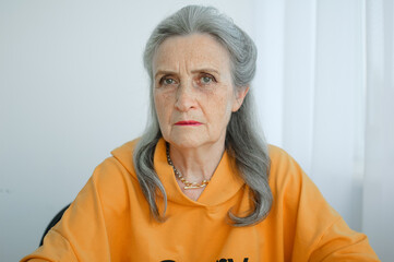 Closeup portrait of angry upset senior mature woman talking with someone and looking at the camera. Negative emotion, facial expression, scandal