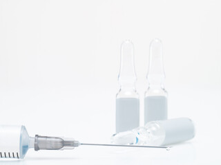 Glass ampoules and medical syringe on white background, isolate