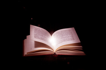 Book With Open Pages And Abstract Lights Shining In Darkness