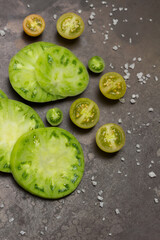 Slices of green tomatoes. Rusty metal background