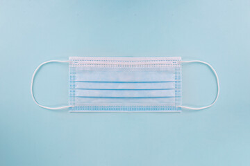 Medical mask, Medical protective mask isolated on blue background. Disposable surgical face mask cover mouth and nose.