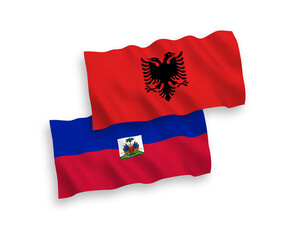 National vector fabric wave flags of Republic of Haiti and Albania isolated on white background. 1 to 2 proportion.