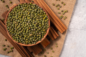 Raw mung bean on wooden table background.