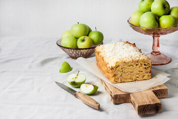 Apple and coconut loaf cake on wooden cutting board