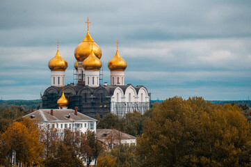 autumn, Christian church with golden domes on the background of autumn foliage. Church Surrounded By Autumn Colors