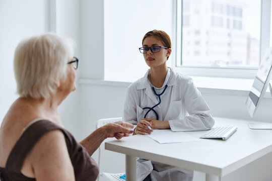 old woman patient talking to a doctor health complaint