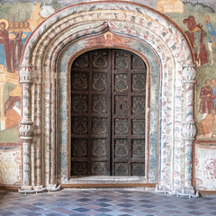 Vintage metal door. old ancient antique doors inside the temple, the walls are painted with...