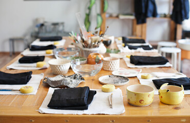 table with tools set for art master class at pottery studio