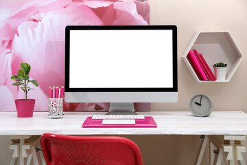 Stylish workplace with modern computer and pink elements indoors. Space for text