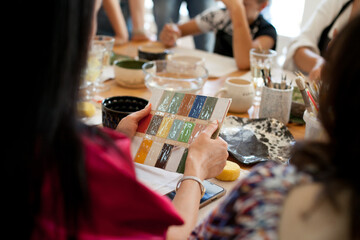 choosing color on color palette at pottery class