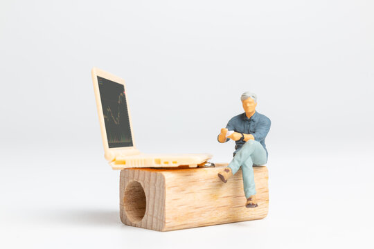 Miniature people, Business people and Laptop featuring stock tickers, Stock market or forex trading graph in graphic concept - Powered by Adobe