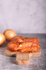 the chicken in the marinade is lying on the board