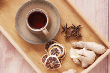 Top view of ginger tea on wooden background.
