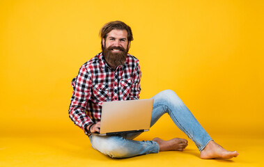 cheerful hipster use computer. modern technology in business. agile business. digital lifestyle concept. mature student working on laptop. guy work on notebook. online shopping
