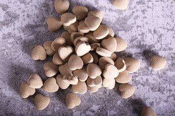 cat food in the shape of a heart is on the table
