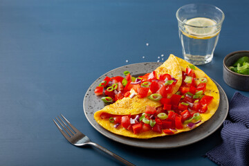 omelette with tomato, bell pepper onion chili and cheese. healthy breakfast