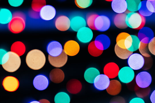 Texture of blurred colored lights on a black background