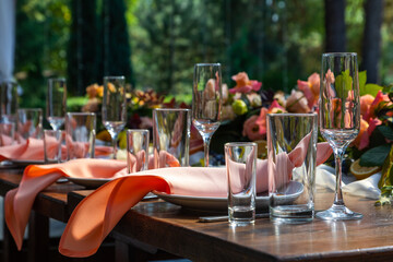 Preparing for an open-air party. Decorated with fresh flowers and fruit. Table number. Decoration Details. Close up detail of served table