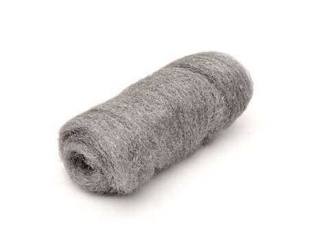 Roll of steel wool abrasive on white