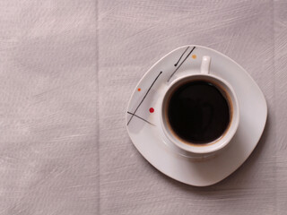 Cup of coffee and beans on a wooden kitchen table
